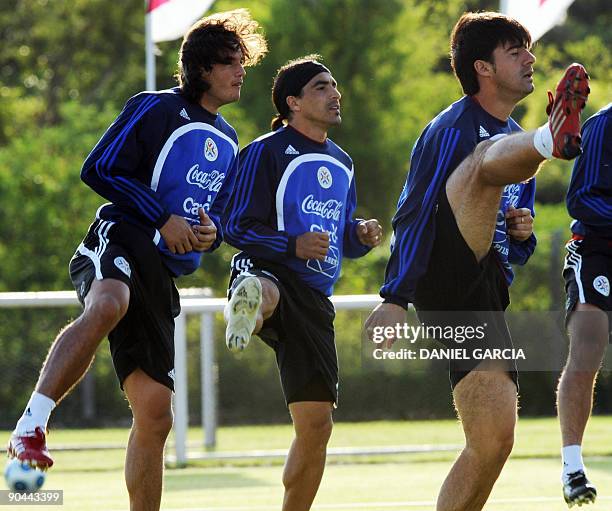 Paraguay's forward Nelson Haedo and defenders Claudio Morel Rodriguez and Julio Caceres exercice during a training session in Ypane, Paraguay, on...