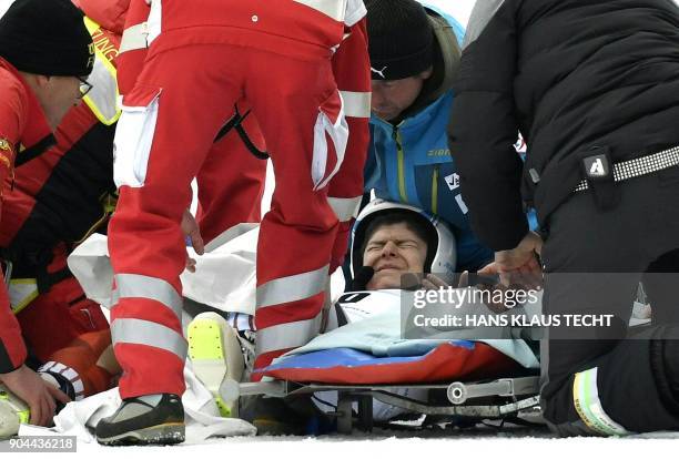 Hungary's Edith Miklos is given medical treatment after the FIS Alpine World Cup Women Super G on January 13, 2018 in Bad Kleinkirchheim. / AFP PHOTO...