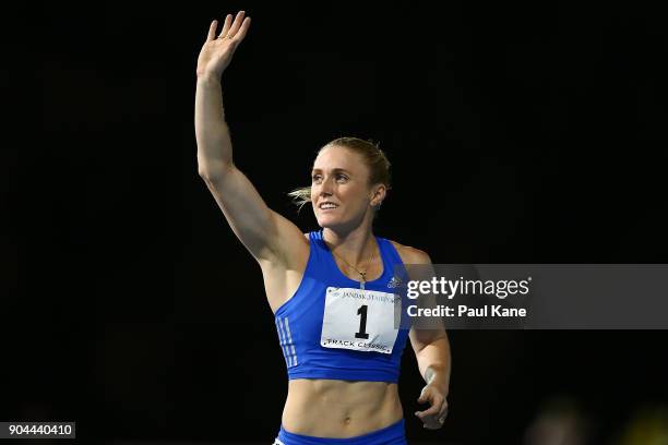 Sally Pearson acknowledges the spectators after competing in and winning the women's 100 metre hurdles during the Jandakot Airport Perth Track...