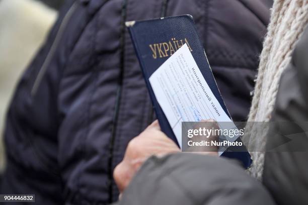 Woman holds a Passport and control ticket Checkpoint &quot;Hnutove&quot; in Hnutove village, near Mariupol, Ukraine on 12 January 2018.