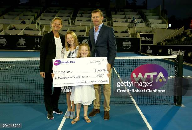 Pat Cunningham and his daughters Maggie and Sophie are presented with a cheque for MND awarness during the 2018 Hobart International at Domain Tennis...