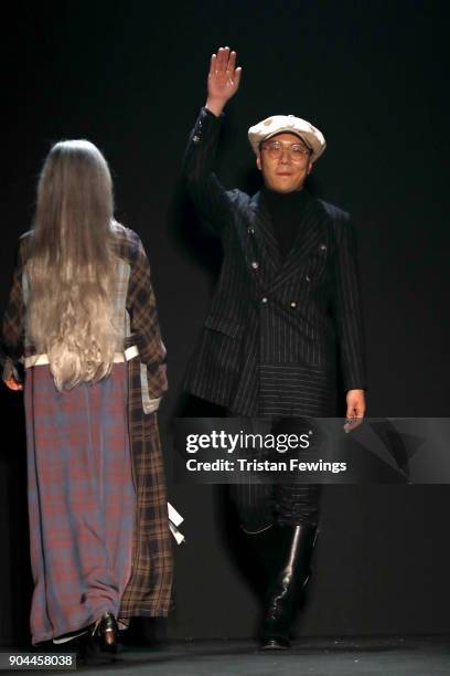 Designers Miao Ran acknowledges the applause of the audience at the Miaoran show during Milan Men's Fashion Week Fall/Winter 2018/19 on January 13,...