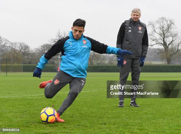 Arsenal manager Arsene Wenger with Alexis Sanchez during a training session at London Colney on January 13, 2018 in St Albans, England.
