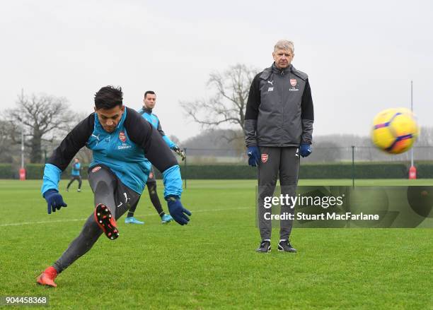 Arsenal manager Arsene Wenger with Alexis Sanchez during a training session at London Colney on January 13, 2018 in St Albans, England.