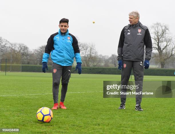 Arsenal manager Arsene Wenger with Alexis Sanchez during a training session at London Colney on January 13, 2018 in St Albans, England.