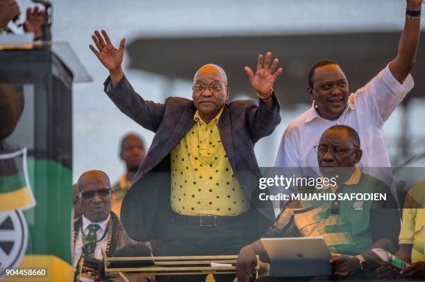 South African President Jacob Zuma and his Kenyan counterpart Uhuru Kenyatta wave at thousands of supporters at the Absa Stadium in East London...