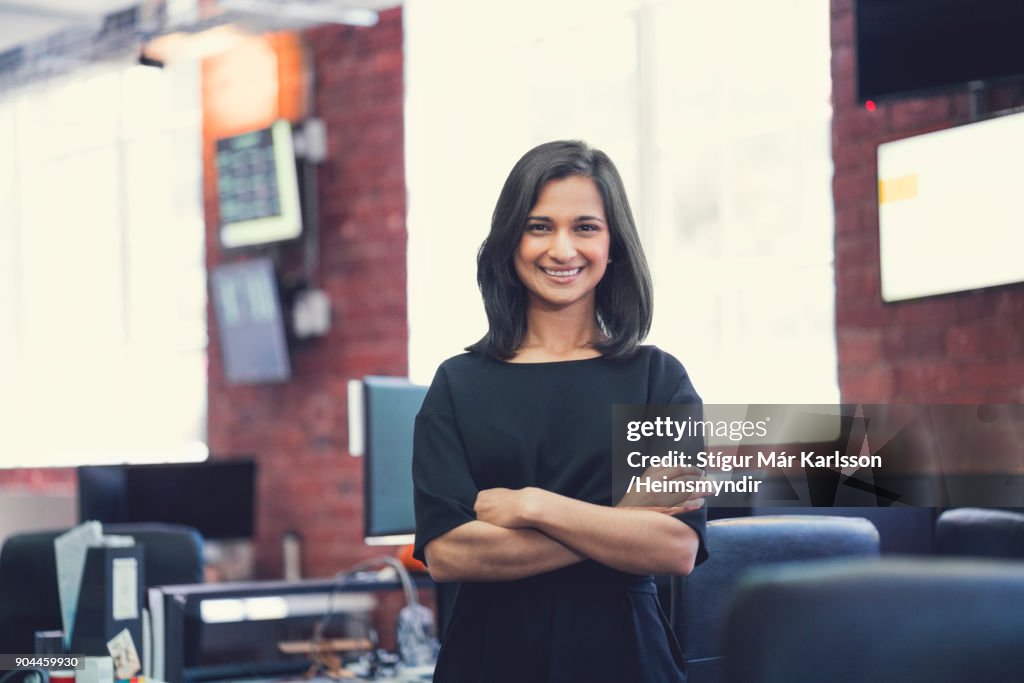 Portrait of smiling businesswoman with arms crossed