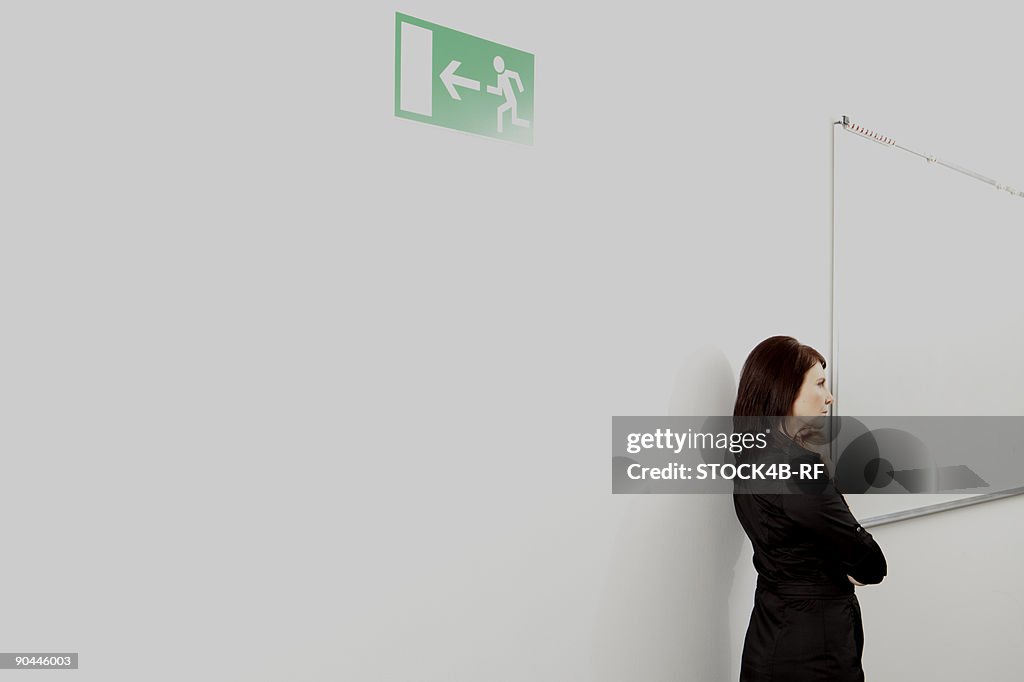 Pensive businesswoman on office corridor, Munich, Bavaria, Germany