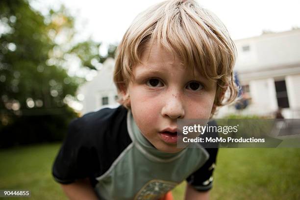 boy (6-7) looking into camera lense - kid peeking stock pictures, royalty-free photos & images