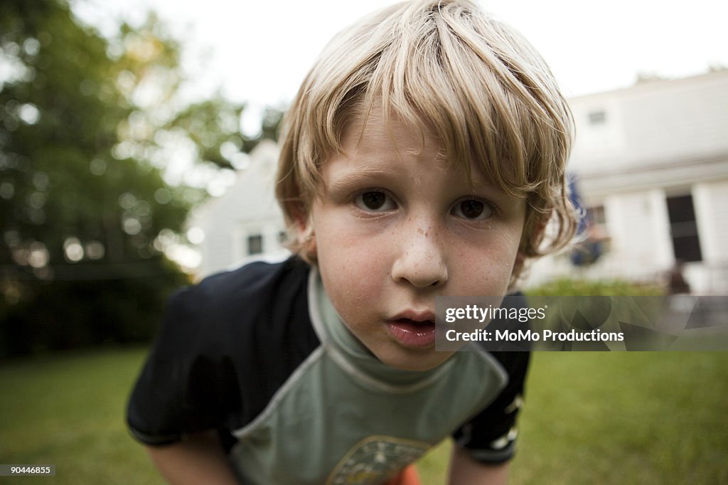 Boy (6-7) looking into camera lense