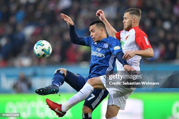 Bobby Wood of Hamburg and Jeffrey Gouweleeuw of Augsburg fight for the ball during the Bundesliga match between FC Augsburg and Hamburger SV at...