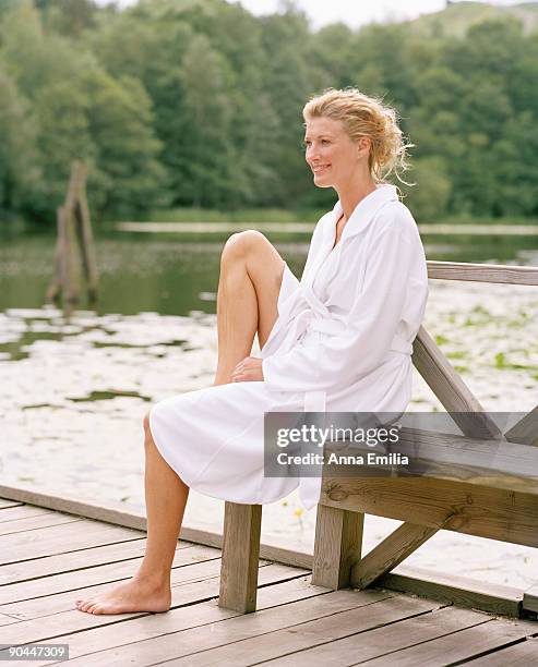 a smiling woman wearing a bathrobe sweden. - robe stock pictures, royalty-free photos & images