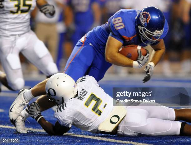 Safety T.J Ward of the Oregon Ducks tackles tight end Kyle Efaw of the Boise State Broncos in the second quarter of the game on September 3, 2009 at...