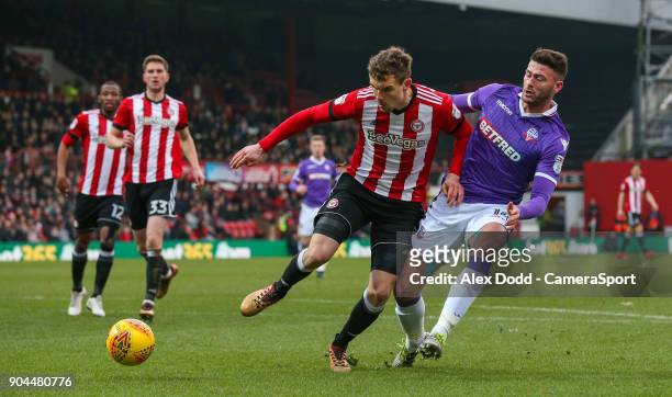 Bolton Wanderers' Gary Madine is tackled by Brentford's Andreas Bjelland during the Sky Bet Championship match between Brentford and Bolton Wanderers...