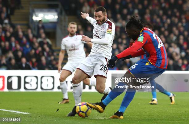 Bakary Sako of Crystal Palace scores his sides first goal as Phil Bardsley of Burnley attempts to block during the Premier League match between...