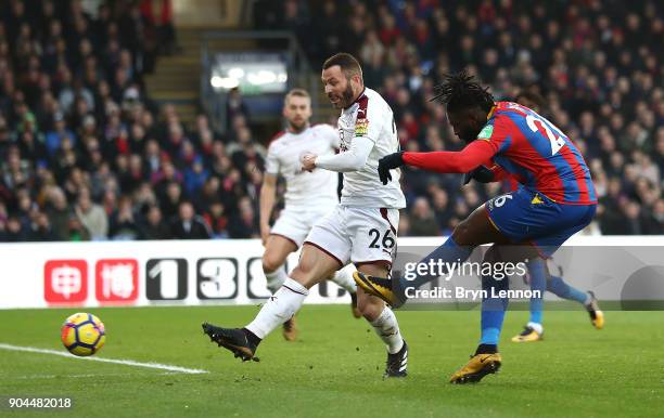 Bakary Sako of Crystal Palace scores his sides first goal as Phil Bardsley of Burnley attempts to block during the Premier League match between...