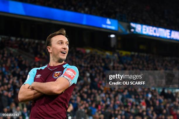 West Ham United's English midfielder Mark Noble celebrates scoring the opening goal during the English Premier League football match between...