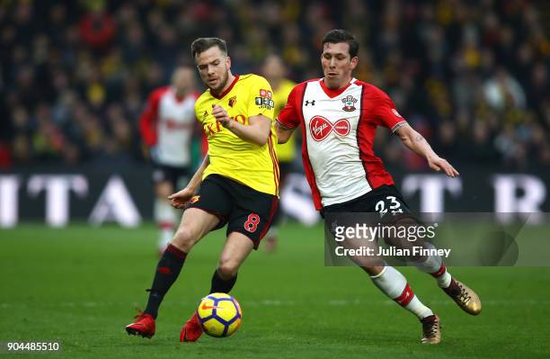 Tom Cleverley of Watford is challenged by Pierre-Emile Hojbjerg of Southampton during the Premier League match between Watford and Southampton at...