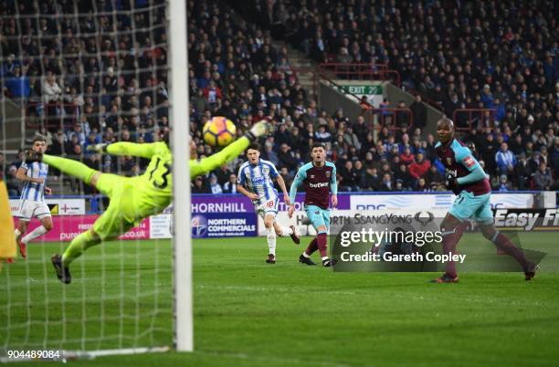 Joe Lolley of Huddersfield Town scores his sides first goal during the Premier League match between Huddersfield Town and West Ham United at John...