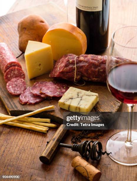 assorted cheeses with salami and red wine - cheese and wine stock-fotos und bilder