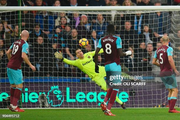 West Ham United's Spanish goalkeeper Adrian dives but fails to save Huddersfield's equalising goal during the English Premier League football match...