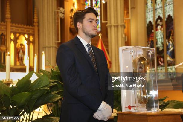 Arcy Murphy the guardian for the St. Francis Xavier relic during its time in Canada, watches over the relic during public veneration at St. Michaels...