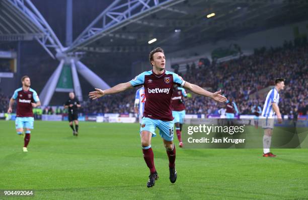 Mark Noble of West Ham United celebrates after scoring his sides first goal during the Premier League match between Huddersfield Town and West Ham...