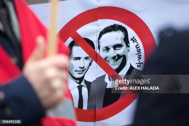 Protesters hold up a sign with the crossed-out Austrian Chancellor Sebastian Kurz and Heinz - Christian Strache during a demonstration against the...