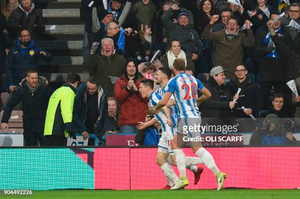 Huddersfield Town's English midfielder Joe Lolley celebrates scoring their first goal to equalise 1-1 during the English Premier League football...