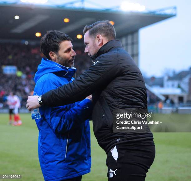 Lincoln City manager Danny Cowley, left, shakes hands with Notts County manager Kevin Nolan prior to the Sky Bet League Two match between Lincoln...