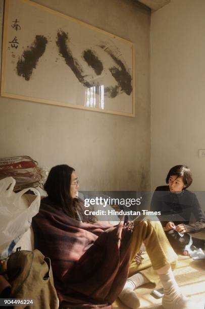 Japanese Miku Watanabe and Shigeru Sebe in a small room with calligraphy 'Kokoro' by master calligrapher Nangaku Kawamata at Japanese...