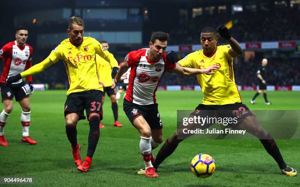 Cedric Soares of Southampton is challenged by Roberto Pereyra of Watford and Marvin Zeegelaar of Watford during the Premier League match between...