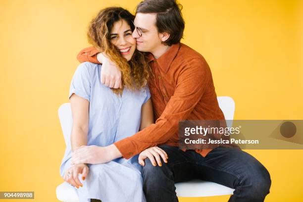 couple embracing in studio - couple coloured background stock pictures, royalty-free photos & images