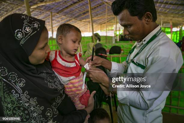 Rohingya refugee is measured at a malnutrition center in Balukhali camp on January 13, 2018 in Cox's Bazar, Bangladesh. Over 650,000 Rohingya have...