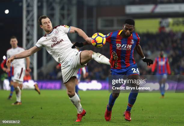 Timothy Fosu-Mensah of Crystal Paalce is challenged by Ashley Barnes of Burnley during the Premier League match between Crystal Palace and Burnley at...