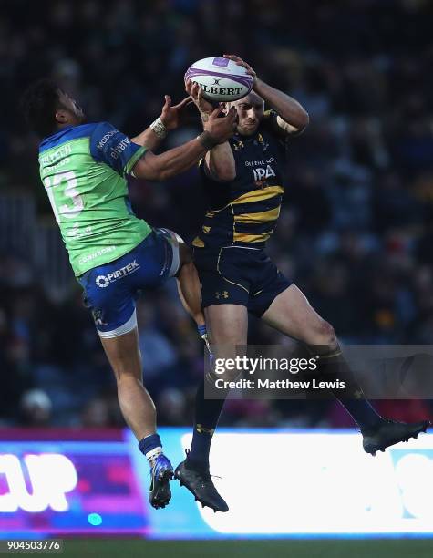 Bundee Aki of Connacht Rugby and Chris Pennell of Worcester Warriors challenge for the ball during the European Rugby Challenge Cup match between...