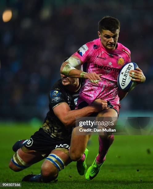 Henry Slade of Exeter Chiefs is tackled by Louis Picamoles of Montpellier during the European Rugby Champions Cup match between Exeter Chiefs and...