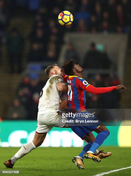 Ben Mee of Burnley battles for a header with Wilfried Zaha of Crystal Palace during the Premier League match between Crystal Palace and Burnley at...