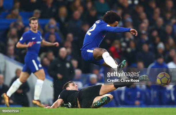 Matty James of Leicester City tackles Willian of Chelsea during the Premier League match between Chelsea and Leicester City at Stamford Bridge on...