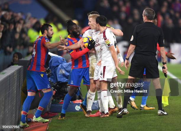 Luka Milivojevic of Crystal Palace and Bakary Sako of Crystal Palace argue with the Burnley players during the Premier League match between Crystal...