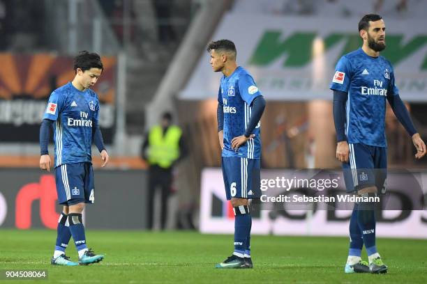 Tatsuya Ito , Douglas Santos and Mergim Mavraj of Hamburg stand on the pitch after the Bundesliga match between FC Augsburg and Hamburger SV at...