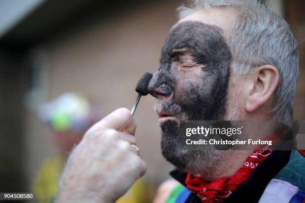 Morris dancer has his face blackened with burnt cork during the annual Whittlesea Straw Bear Festival parade on January 13, 2018 in Whittlesey,...