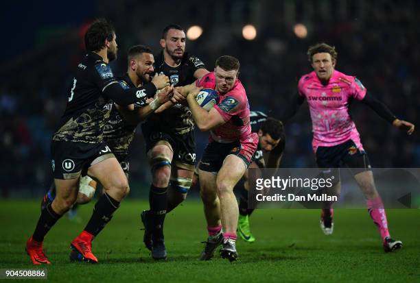Sam Simmonds of Exeter Chiefs is tackled by Aaron Cruden and Louis Picamoles of Montpellier during the European Rugby Champions Cup match between...