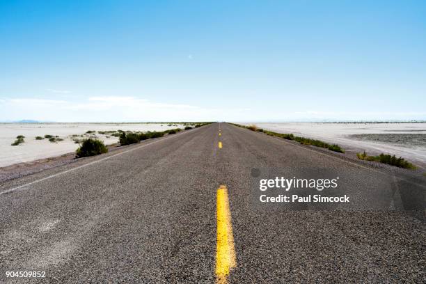 utah, wendover, bonneville salt flats, blue sky over empty road - wendover stock pictures, royalty-free photos & images