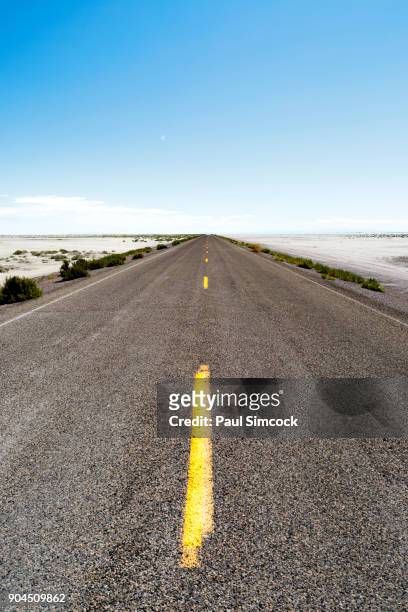 utah, wendover, bonneville salt flats, blue sky over empty road - wendover stock pictures, royalty-free photos & images
