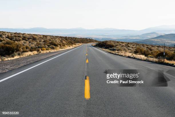 california, eastern sierras, route 88, sky over empty road - 一重黄線 ストックフォトと画像