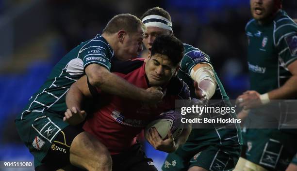 Fangatapu Apikotoa of Krasny Yar is tackled by David Paice of London Irish during the European Rugby Challenge Cup between London Irish and Krasny...