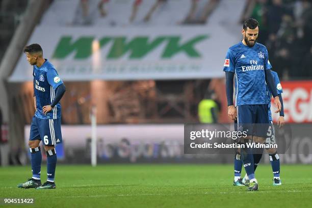 Douglas Santos of Hamburg, Mergim Mavraj of Hamburg and Tatsuya Ito of Hamburg dejected after the Bundesliga match between FC Augsburg and Hamburger...