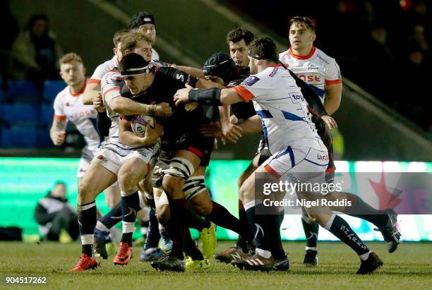 Will Addison and Rob Webber of Sale Sharks tackled by Francois Van Der Merwe of Lyon during the European Rugby Challenge Cup match between Sale...