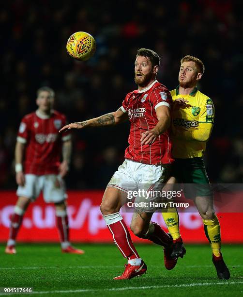 Nathan Baker of Bristol City is tackled by Harrison Reed of Norwich City during the Sky Bet Championship match between Bristol City and Norwich City...